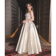 A luxurious evening gown in a pearl-toned ivory color with an elegant design