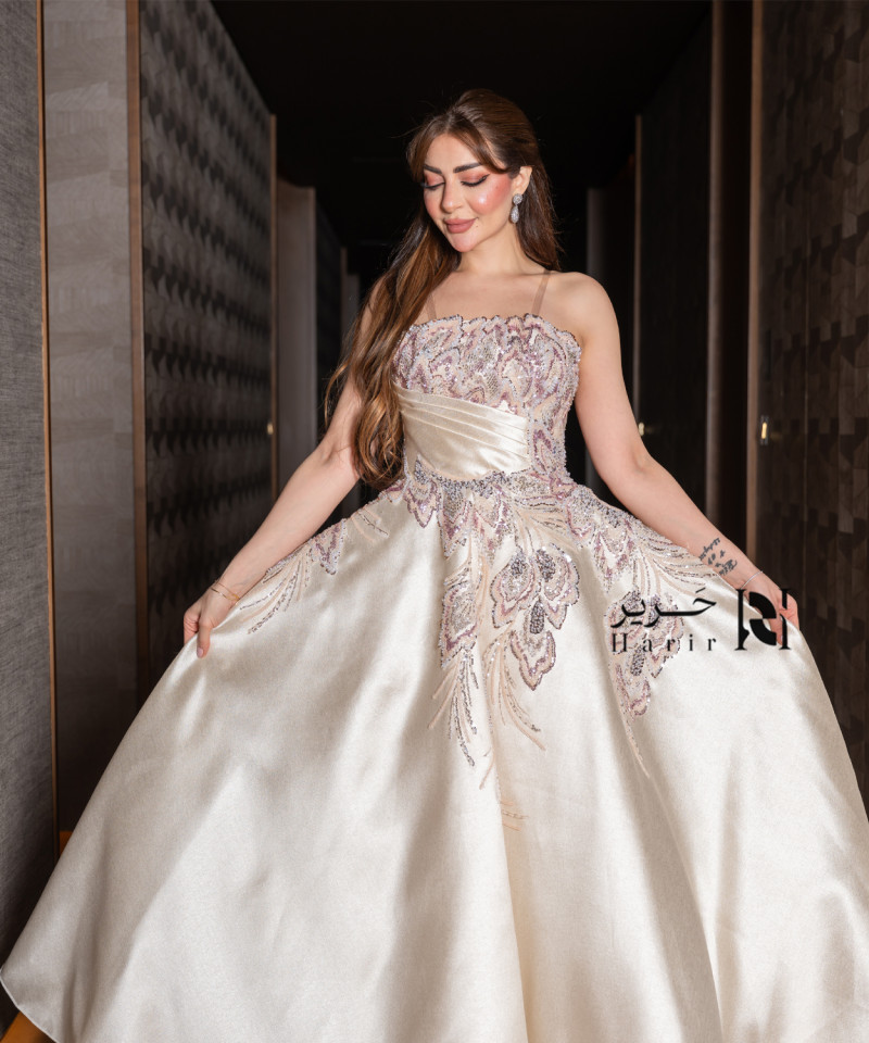 A luxurious evening gown in a pearl-toned ivory color with an elegant design
