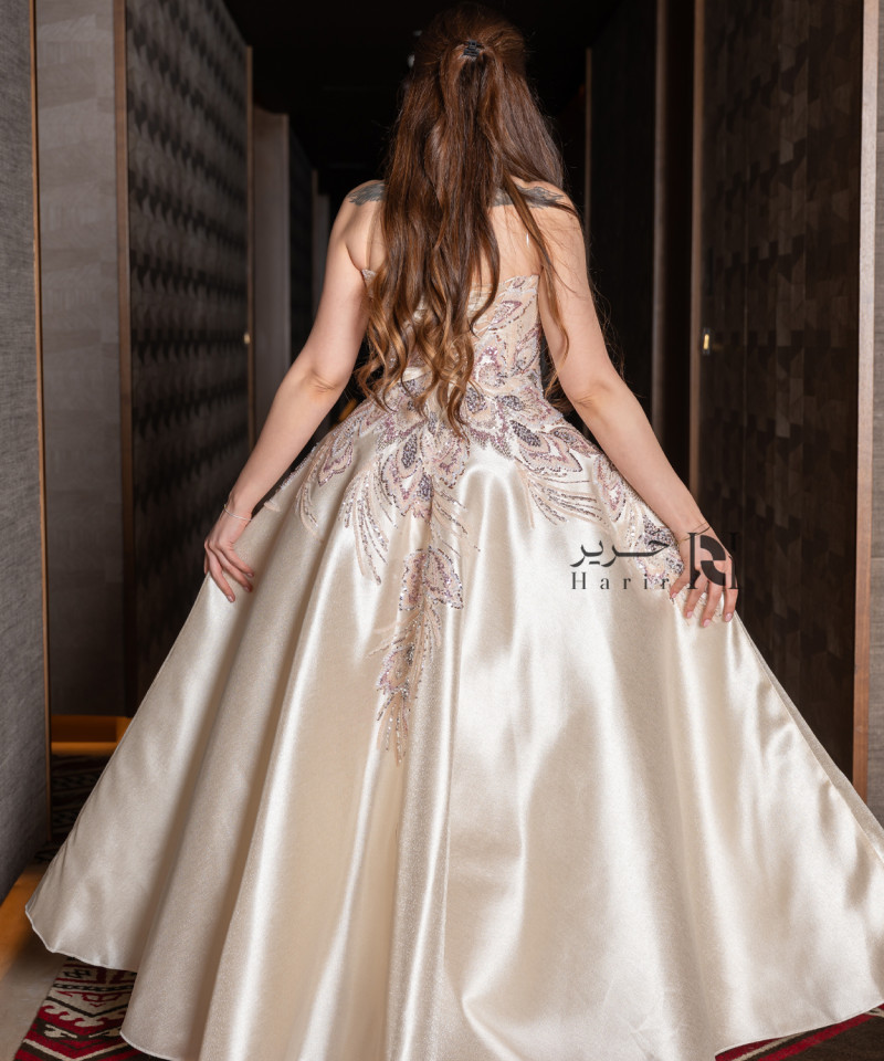 A luxurious evening gown in a pearl-toned ivory color with an elegant design