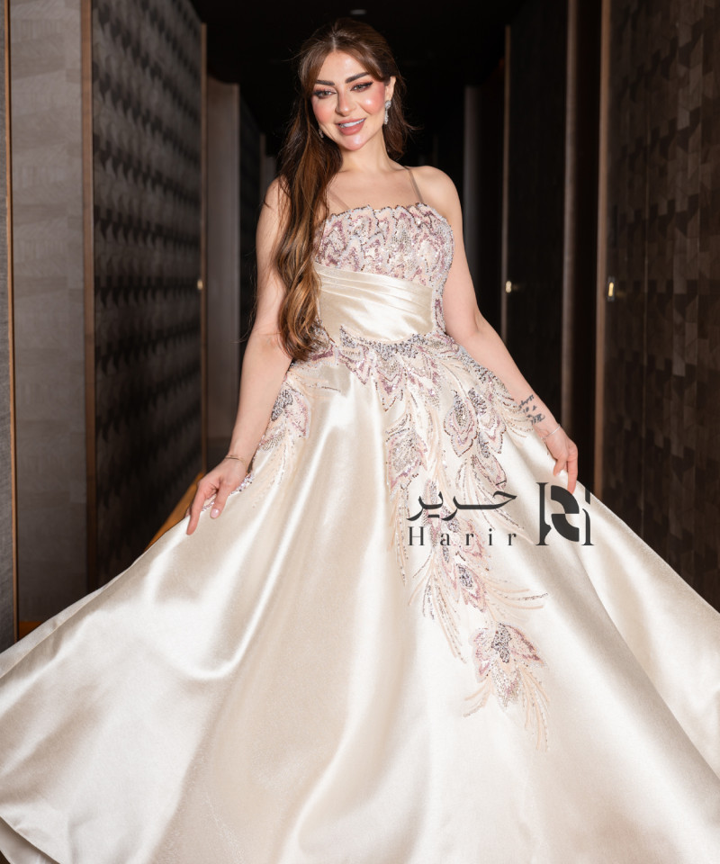 A luxurious evening gown in a pearl-toned ivory color with an elegant design