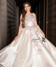 A luxurious evening gown in a pearl-toned ivory color with an elegant design