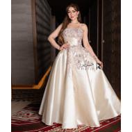 A luxurious evening gown in a pearl-toned ivory color with an elegant design