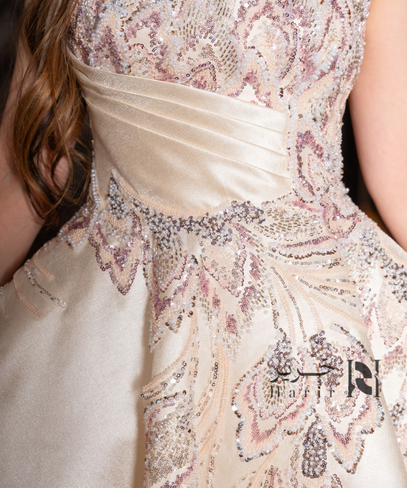 A luxurious evening gown in a pearl-toned ivory color with an elegant design