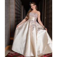 A luxurious evening gown in a pearl-toned ivory color with an elegant design