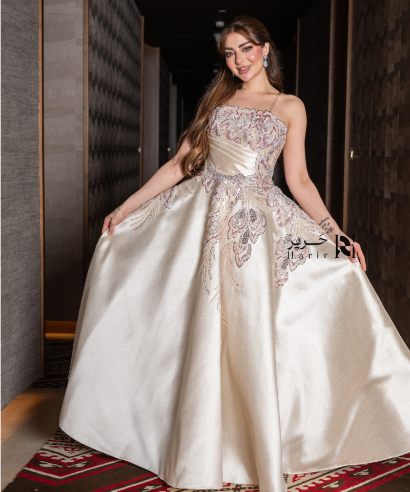 A luxurious evening gown in a pearl-toned ivory color with an elegant design