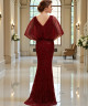 Elegant red dress with hand embroidery and wide sheer sleeves.