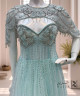 فستان سهرة أخضر فاتح بتطريز كريستالي فاخر وياقة مستديرة