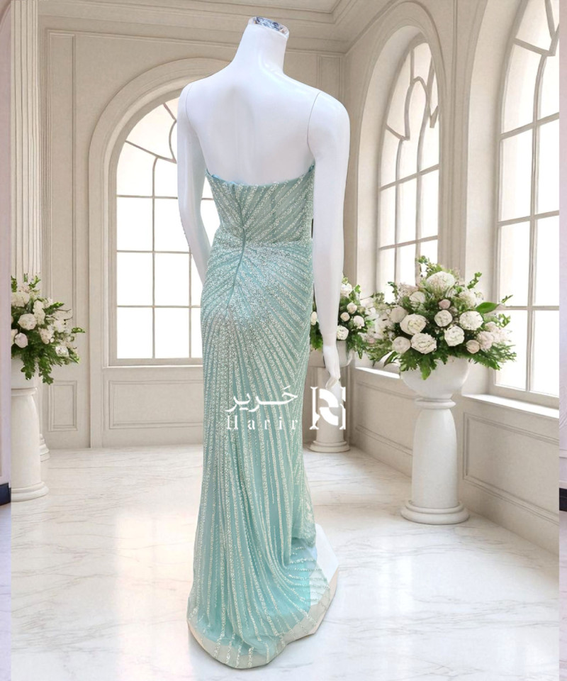 فستان سهرة أخضر فاتح بكشكشة تول وتطريز لامع يدوي