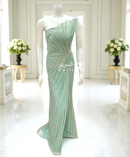 فستان سهرة أخضر فاتح بكشكشة تول وتطريز لامع يدوي