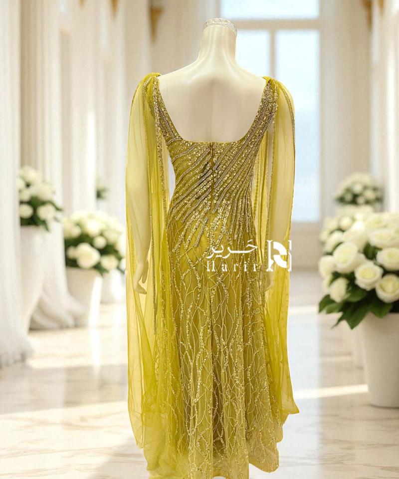 فستان سهرة أصفر فاخر بتطريز يدوي وانسيابية تول