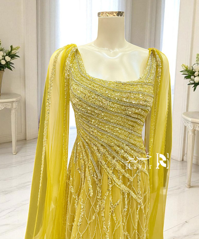 فستان سهرة أصفر فاخر بتطريز يدوي وانسيابية تول