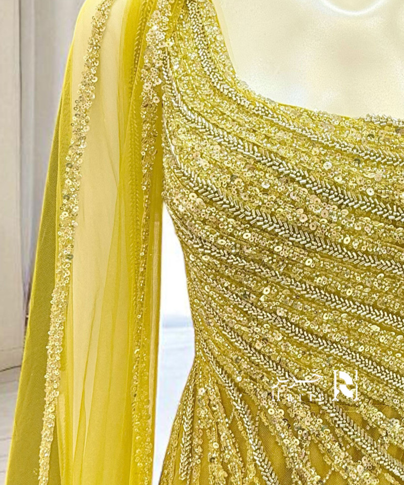 فستان سهرة أصفر فاخر بتطريز يدوي وانسيابية تول