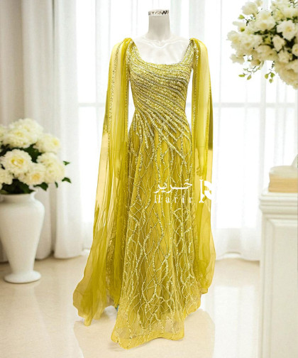 فستان سهرة أصفر فاخر بتطريز يدوي وانسيابية تول