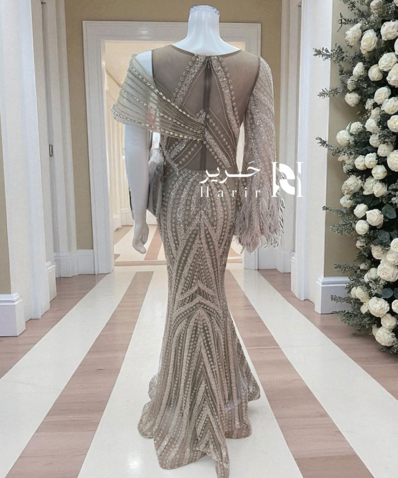 فستان سهرة بني فاتح بتطريز فاخر وكتف مائل بتفاصيل كريستالية