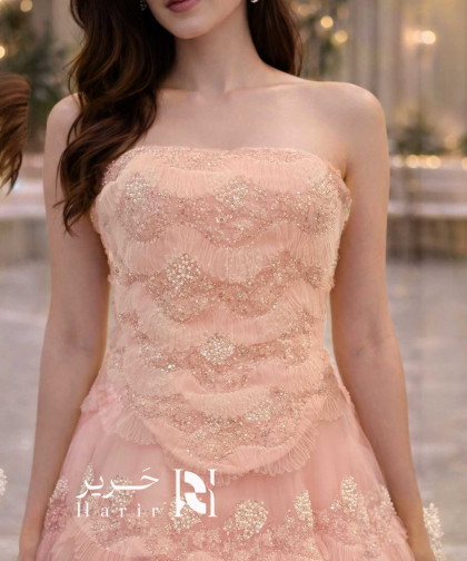 فستان سهرة وردي فاتح بطبقات تول مطرّزة وتصميم كورسيه