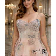 Blush nude strapless sweetheart evening dress with floral beaded corset and layered tulle skirt.