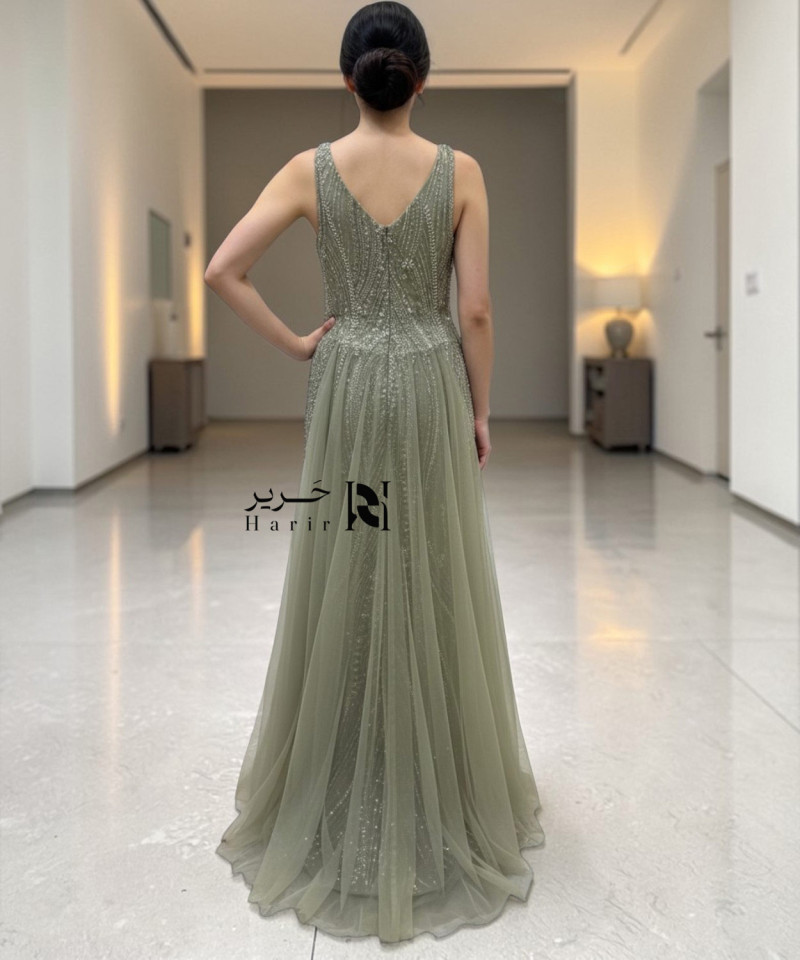 Olive green one-shoulder evening dress with beaded embroidery and side tulle drape.