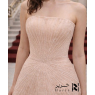 فستان سهرة شامبين لؤلؤي بتصميم كورسيه فاخر وتطريز إشعاعي ناعم