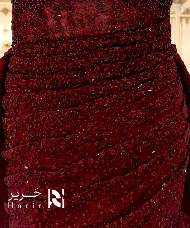Luxury burgundy evening dress with shimmering embellishments and off-shoulder sleeves